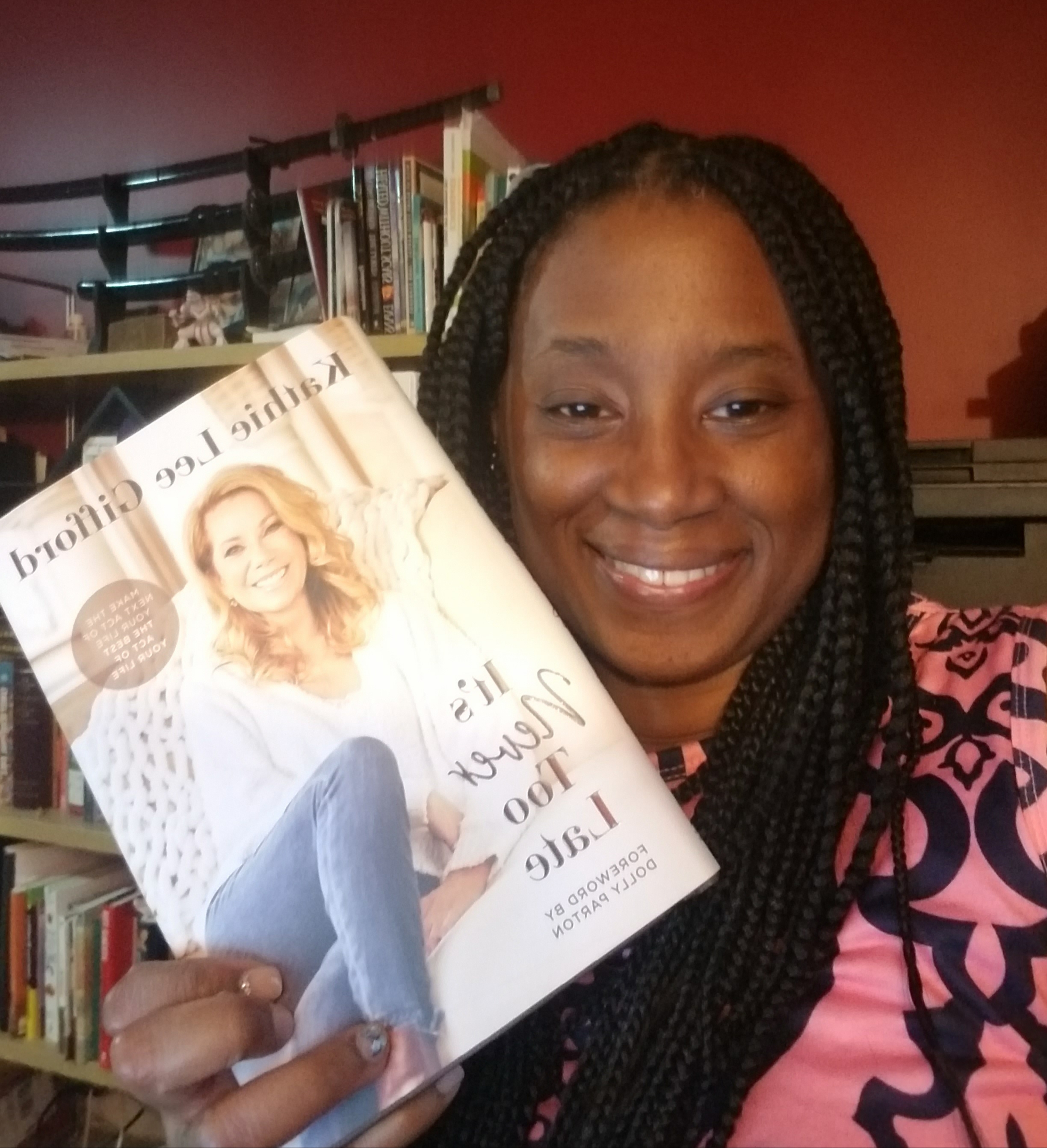 smiling woman with it's never too late book