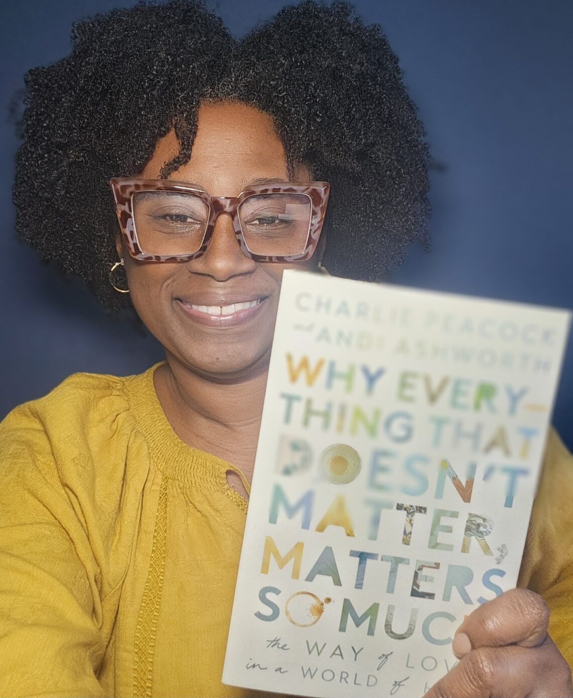 Female in yellow holding Why Everything That Doesn't Matter, Matters